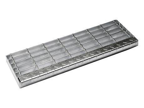 A stair tread steel grating is fixed by welding.