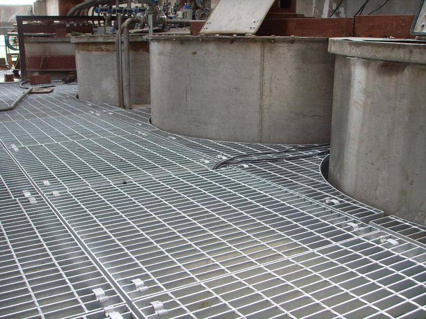 Several galvanized steel gratings are installed on the factory platform.