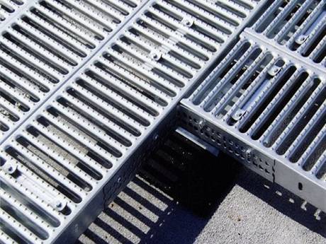 Several interlocking safety gratings placed on the ground.