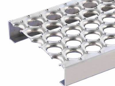 A o-grip safety grating with five rows of holes.