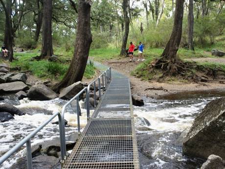 The steel grating bridge crossing the creek.