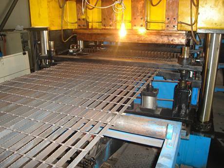 A machine is producing steel bar grating.