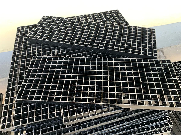 Many black painted steel grating stocked together.
