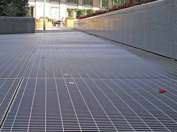 Les grilles métalliques sont utilisées comme sols dans un quartier d'affaires.