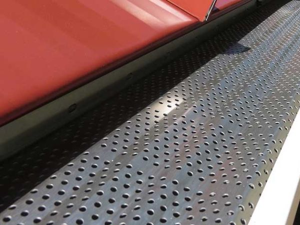 Aluminum gutter guard is installed on metal roofs.