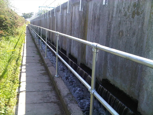 Install modular handrails at the pedestrian walkway outside the drainage ditch