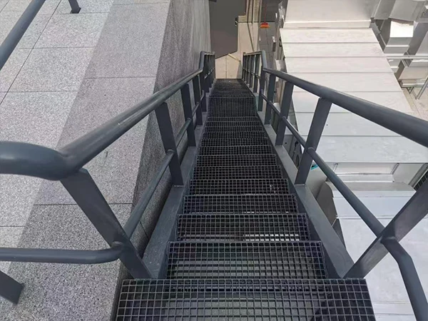 Black painted steel grating installed in indoor venues as stair treads