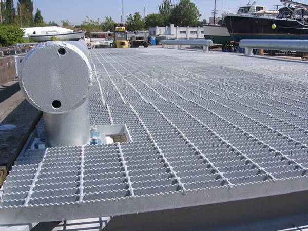 Welded platform grating with serrated surface.
