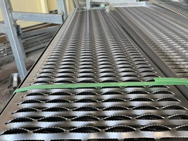 Rooftop solar panel walkways with raised perforations