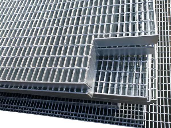 Deux morceaux de caillebotis en acier soudé sont coupés un coin pour les tuyaux.