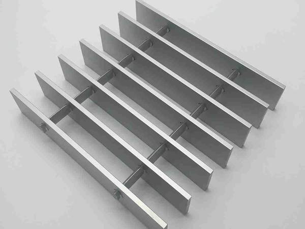 A piece of aluminum swage locked grating with smooth surface.