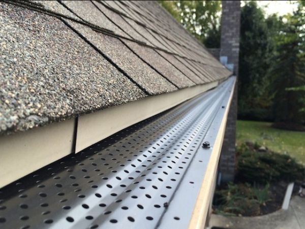 Aluminum gutter guard is installed on tile roofs.